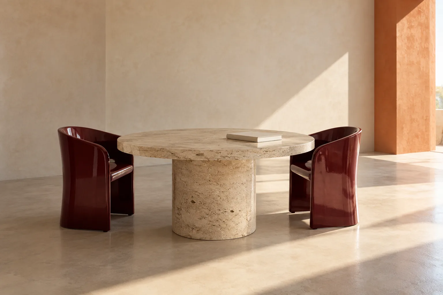A sunlit stone table and two burgundy chairs, an architectural still life